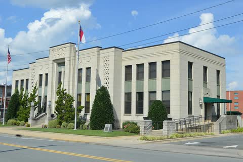 Pale stone municipal building with flags on North Church Street in Asheboro