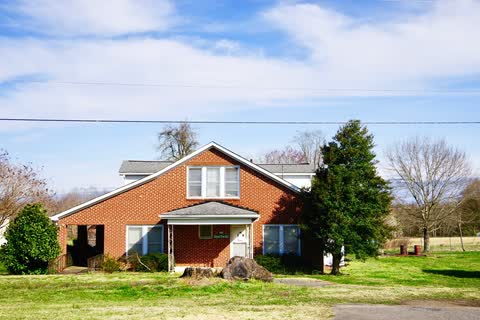 Brick Belwood town hall building with a lawn