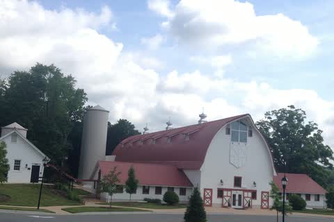 The Win-Mock Farm dairy barn in Bermuda Run, a large white barn with a red gambrel roof and a silo