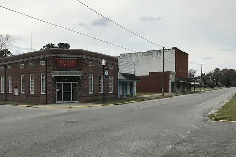 A one-story brick municipal building on a street corner in Bethel