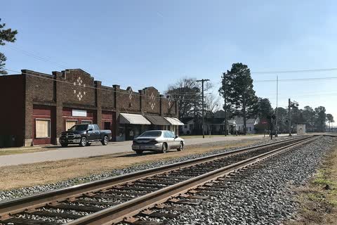Brick storefronts facing a railroad line in Black Creek
