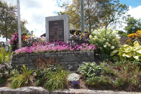 Flower beds and a stone memorial in Memorial Park in downtown Blowing Rock