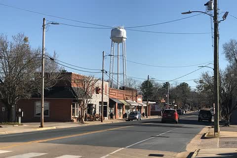 Small-town main street in Broadway with a water tower above the storefronts