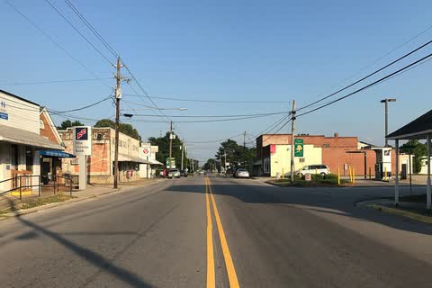 A two-lane street lined with small commercial buildings in Bunn