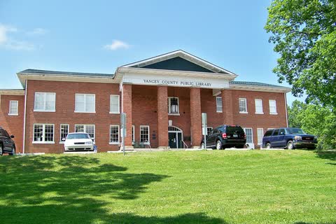 Brick Yancey County Public Library with a columned entrance and lawn in Burnsville