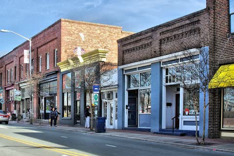 Row of brick and painted storefronts along East Main Street in Carrboro