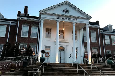 The Cary Arts Center in Cary, a brick former school with a white-columned entrance and wide front steps