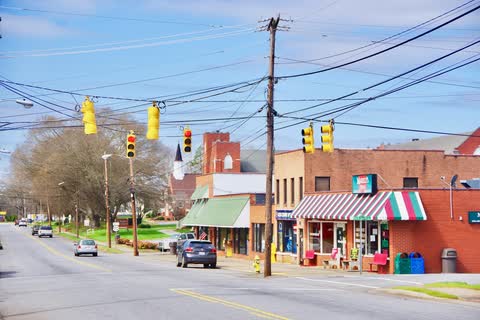 Main Street in Claremont with brick and painted storefronts at an intersection
