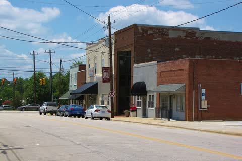 One- and two-story brick buildings along Main Street in Coats