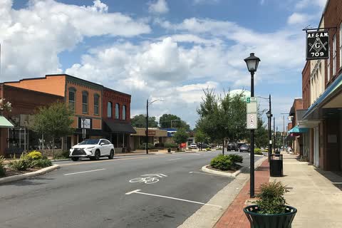 Brick buildings, a street lamp and a planter along a downtown street in Conover