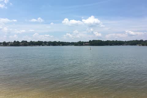 Calm water of Lake Norman with a tree-lined far shore, seen from Ramsey Creek Park