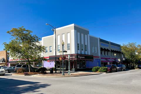 White and brick commercial buildings at a downtown street corner in Morganton