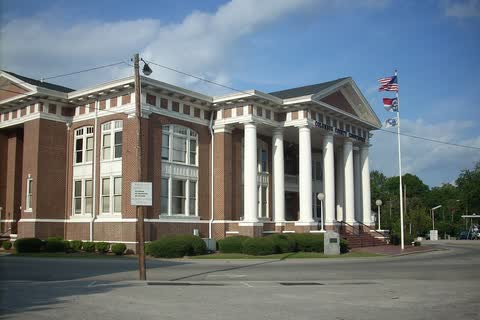 A brick courthouse with a white columned portico in Whiteville, North Carolina
