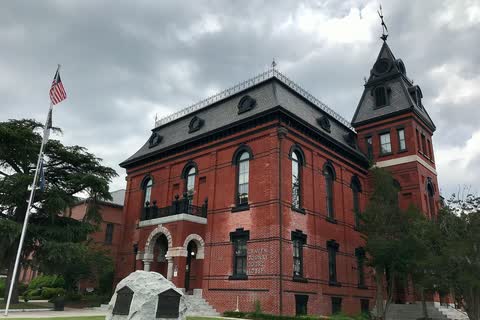 A red-brick Victorian courthouse with a corner tower in New Bern, North Carolina