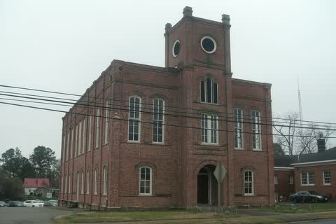 A tall red-brick courthouse with a square tower in Williamston, North Carolina
