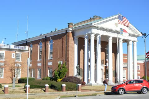 A brick courthouse with a tall white-columned portico in Nashville, North Carolina