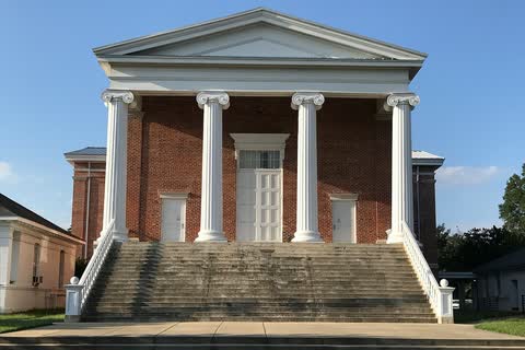 A brick courthouse with white columns above a wide flight of steps in Jackson, North Carolina