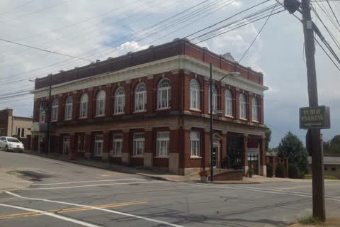 Red brick old city hall building at a street corner in Rutherfordton