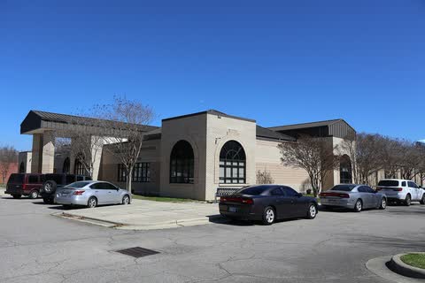 Modern low courthouse with arched windows and a covered entrance