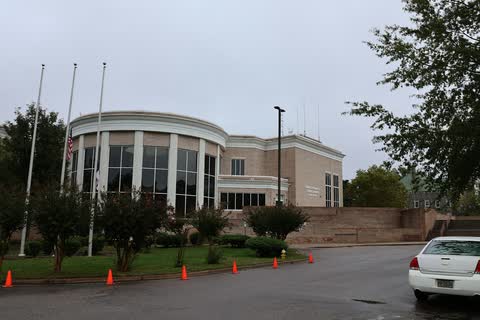 A modern brick courthouse with a curved glass front in Henderson, North Carolina