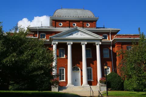 Red brick courthouse with white columns and a domed roof in Danbury