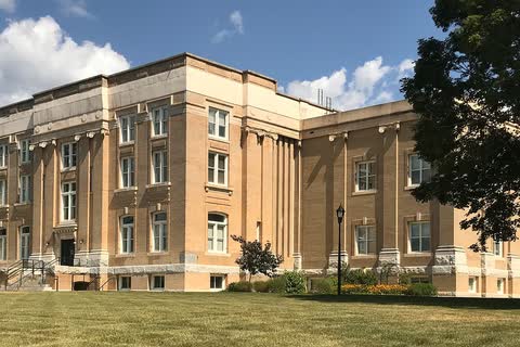Tan stone Surry County Courthouse building with tall windows in Dobson