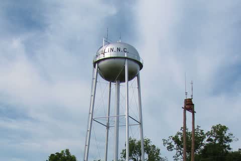 A water tower rising above a small green-roofed town hall building in Dublin