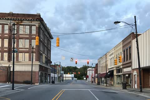 Street in the historic Leaksville section of Eden with a tall brick building on the corner
