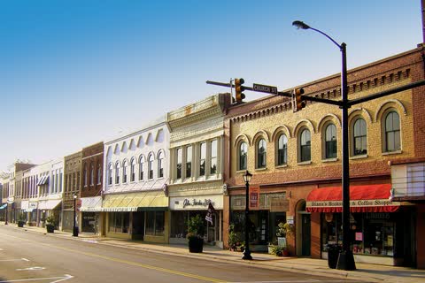 Row of restored historic storefronts and a street lamp in downtown Elkin