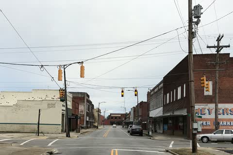 A downtown intersection in Enfield with brick buildings and traffic signals