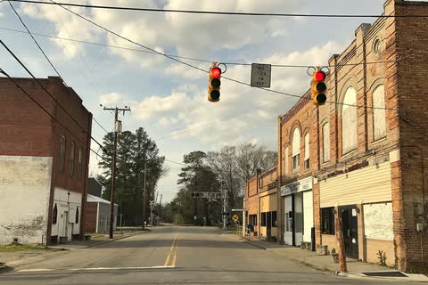 Brick commercial buildings at a crossroads with a traffic signal in Everetts
