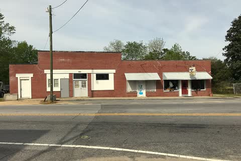 A low brick commercial building beside a road in Falkland