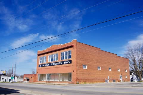Two-story brick Stamey Stores building with a painted sign in Fallston