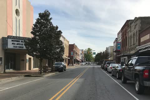 A downtown street in Farmville with a theater marquee and storefronts