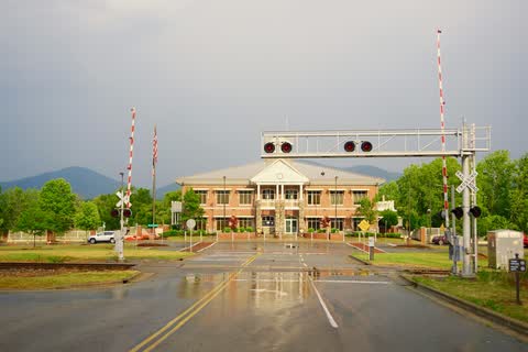 Fletcher Town Hall seen across a railroad crossing with mountains behind