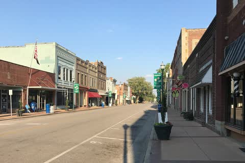 Brick storefronts with awnings and planters along a downtown street in Fremont