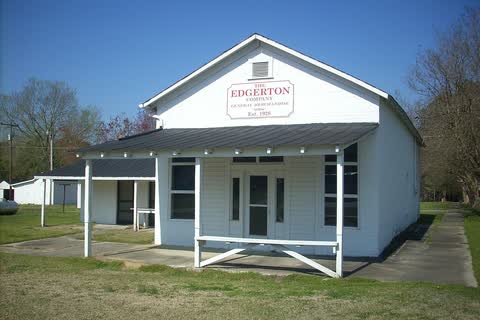 The white wooden Edgerton Company store in Godwin, with a covered porch along its front