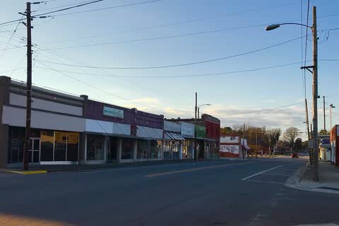 A row of low commercial buildings along a street in Grifton