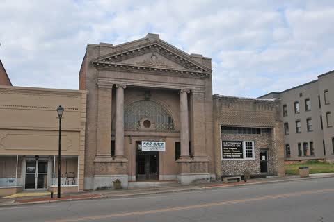 Classical-style brick and stone building with columns on Main Street in Hamlet