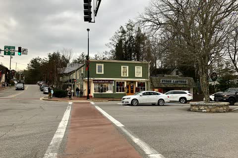 Main Street crosswalk in Highlands with a green two-story shop building