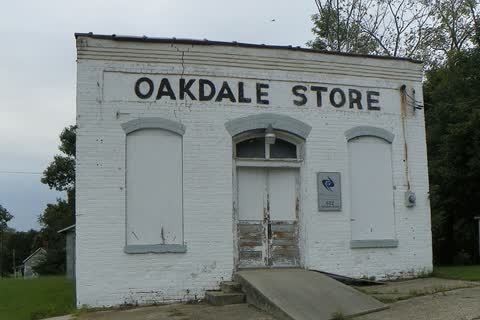 The old white-painted brick Oakdale Store in Jamestown, with OAKDALE STORE lettered above the door