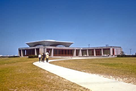 The low modernist Wright Brothers National Memorial visitor center in Kill Devil Hills, at the end of a curving walkway