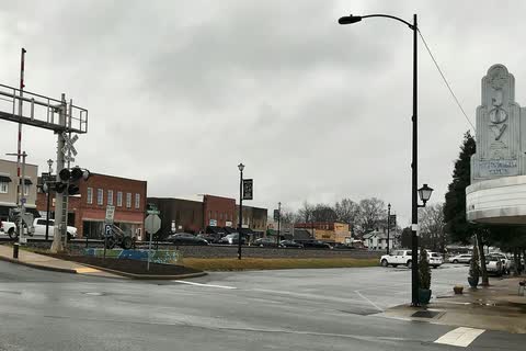 Downtown Kings Mountain street at a railroad crossing on an overcast day