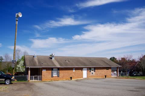 Low brick Kingstown town hall building under a blue sky