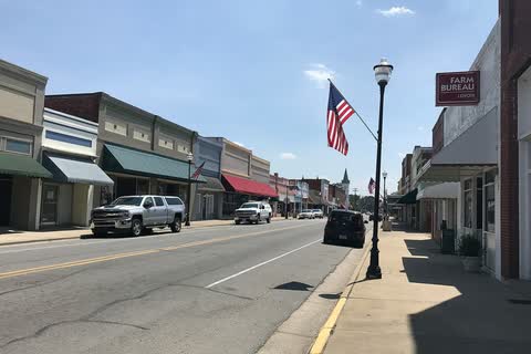 Storefronts and an American flag along the main street in La Grange