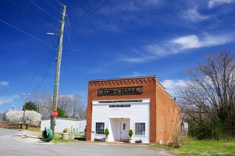 Small white town hall building with a brick front in Lattimore