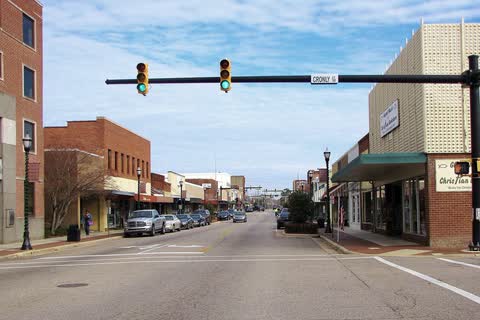 Main Street in Laurinburg with traffic lights and brick storefronts on both sides