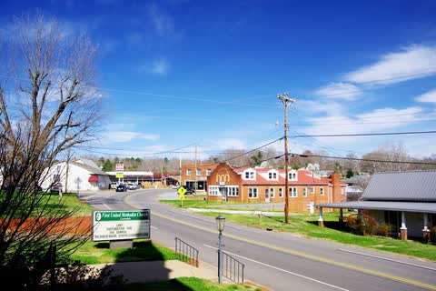 Main Street in Lawndale with brick buildings and trees in spring