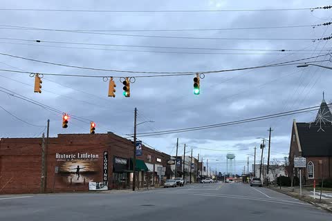 Brick buildings along a downtown street in Littleton under traffic signals