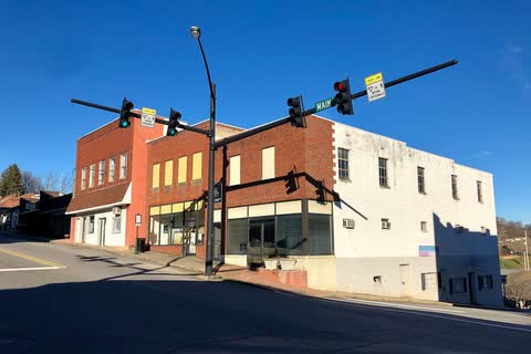 Brick and white commercial buildings at a Main Street intersection in Mars Hill